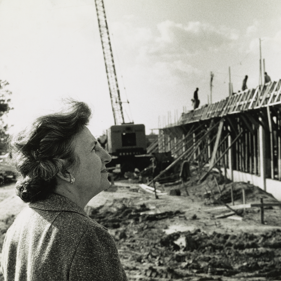 Bonnie Cone looking at the Library Building under construction in 1963.